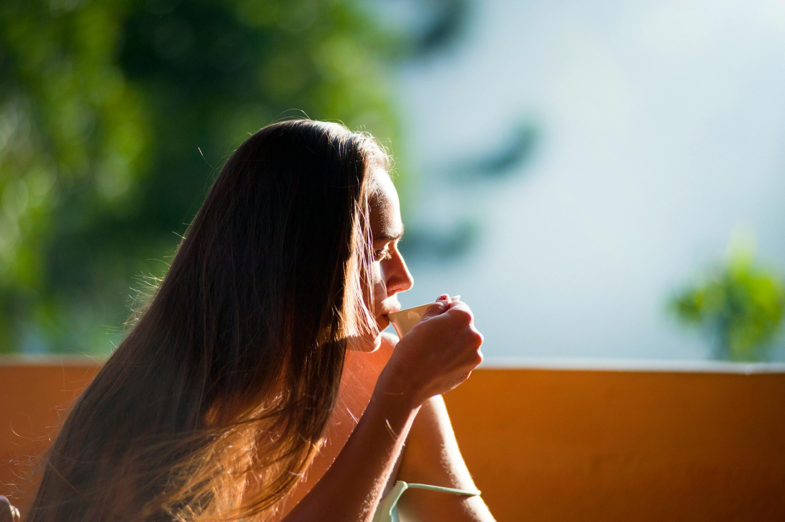 Person standing in morning sunlight symbolizing natural Vitamin D production